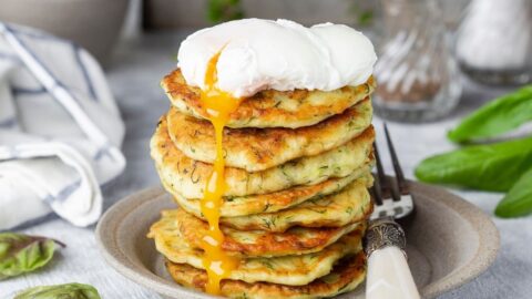 A Stack of Zucchini Fritter with Poached Egg