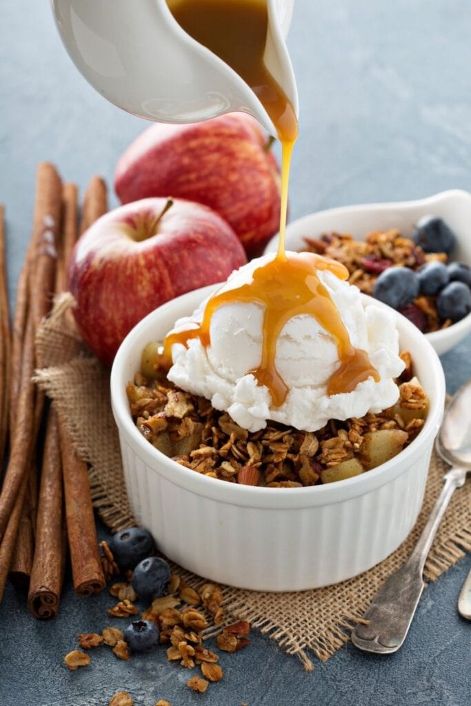 20 Best Honeycrisp Apple Recipes for Fall featuring Apple Crisp with Ice Cream with Maple Syrup in a Ramekin Bowl