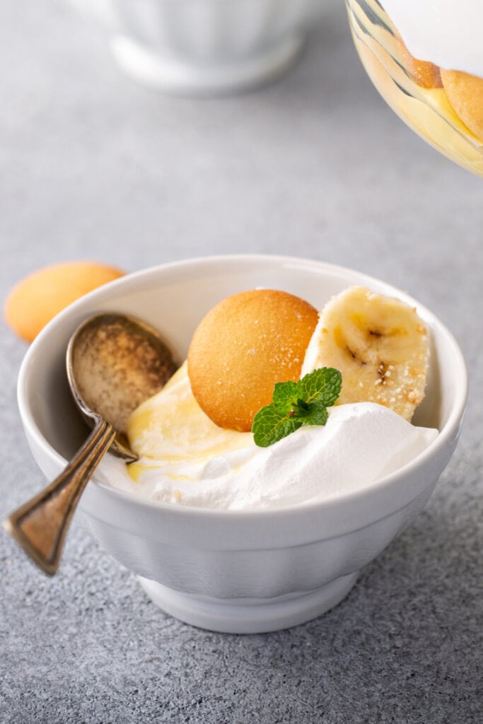 Banana Pudding Trifle with Vanilla Wafers and a Slice of Banana in a Small Bowl