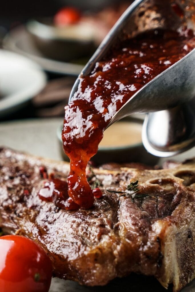 17 Steak Sauce Recipes That Go Beyond A1 featuring Beef Steak Poured with Cranberry Sauce