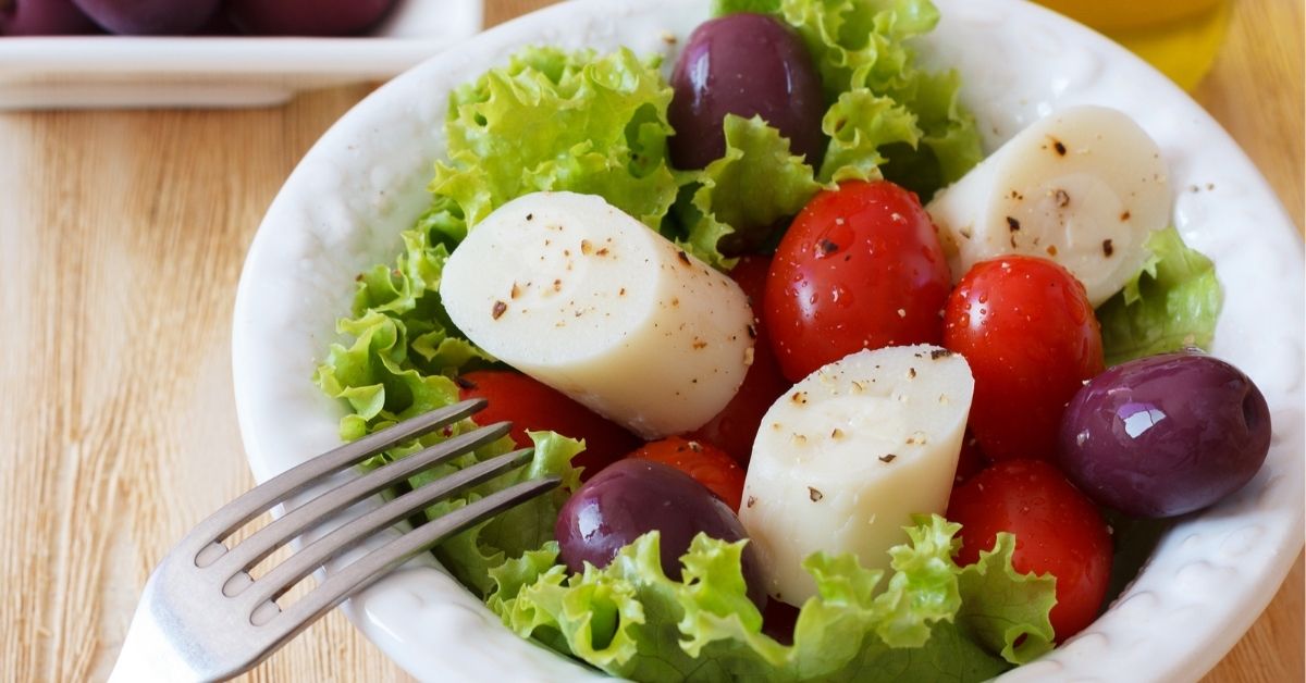 Bowl of Hearts of Palm Salad with Cherry Tomatoes and Olives