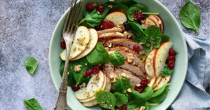 Bowl of Homemade Apple Chicken Salad with Dried Cranberries and Walnuts