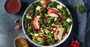 Bowl of Homemade Kale Salad with Apples and Pomegranate