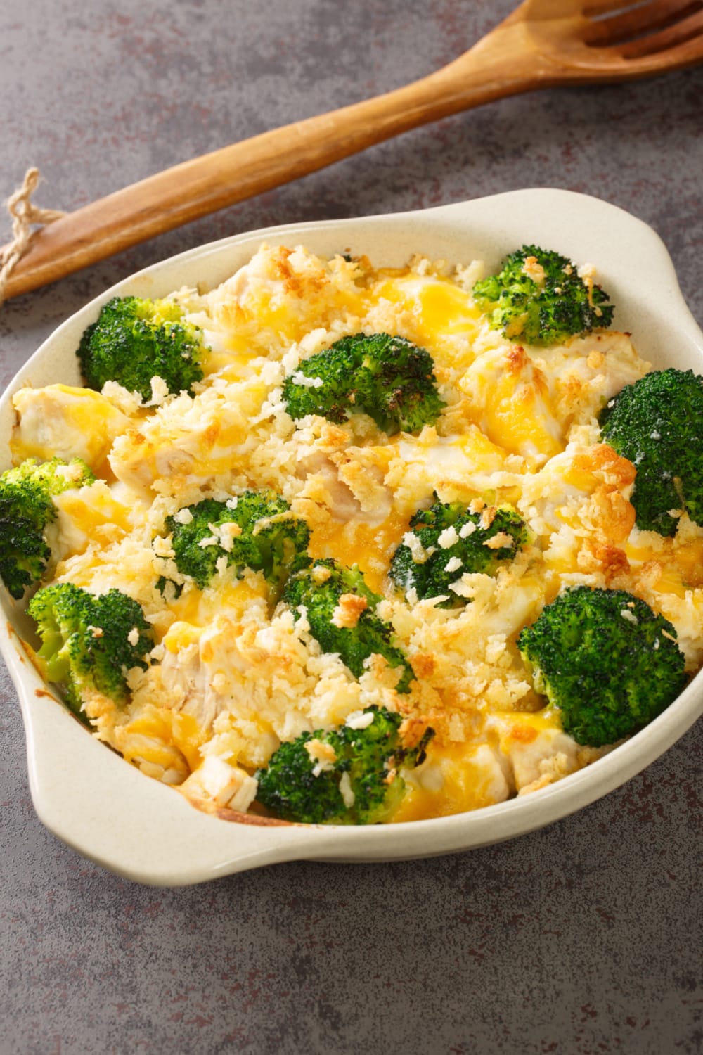 Cheesy chicken and broccoli casserole served on a white dish.