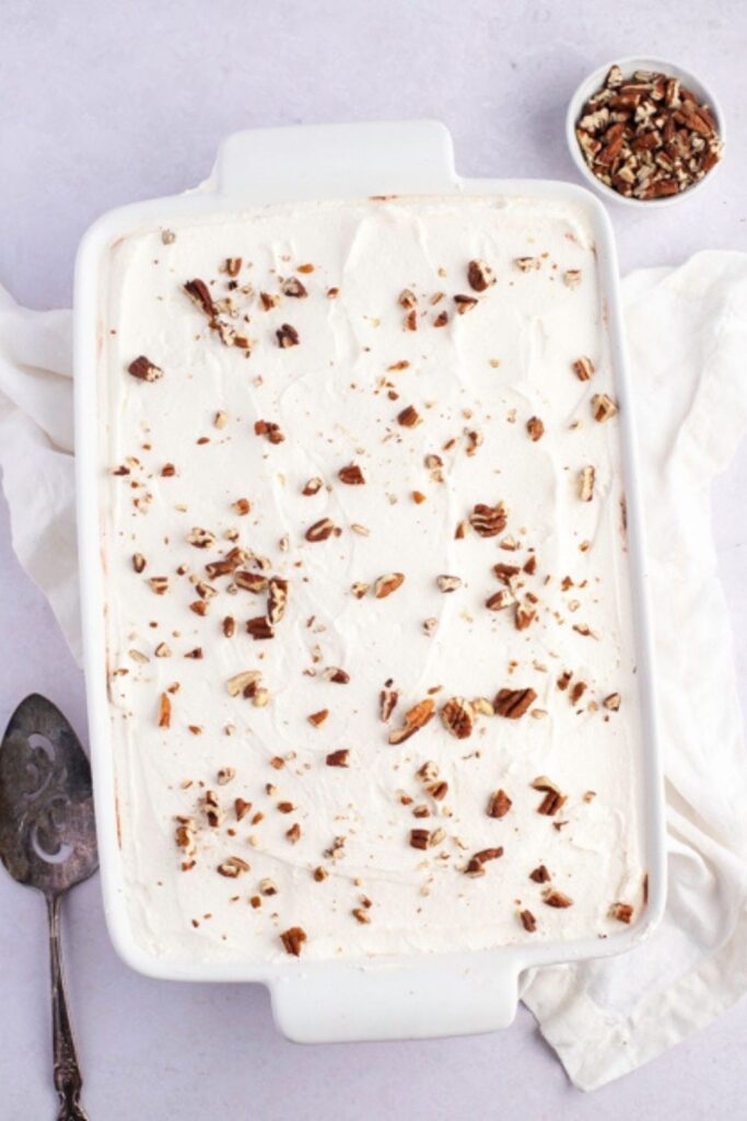 Easy Chocolate Delight in a Pan Topped With Whipped Cream and Crumbled Nuts