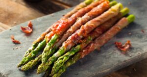Homemade Bacon-Wrapped Asparagus in a Chopping Board