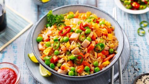 Homemade Fried Rice with Spam, Carrots and Green Peas in a Bowl