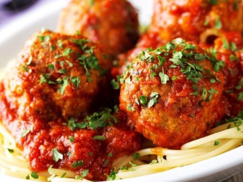 https://insanelygoodrecipes.com/wp-content/uploads/2022/03/Spaghetti-and-Meatballs-with-Herbs-in-a-White-Plate-500x375.jpg