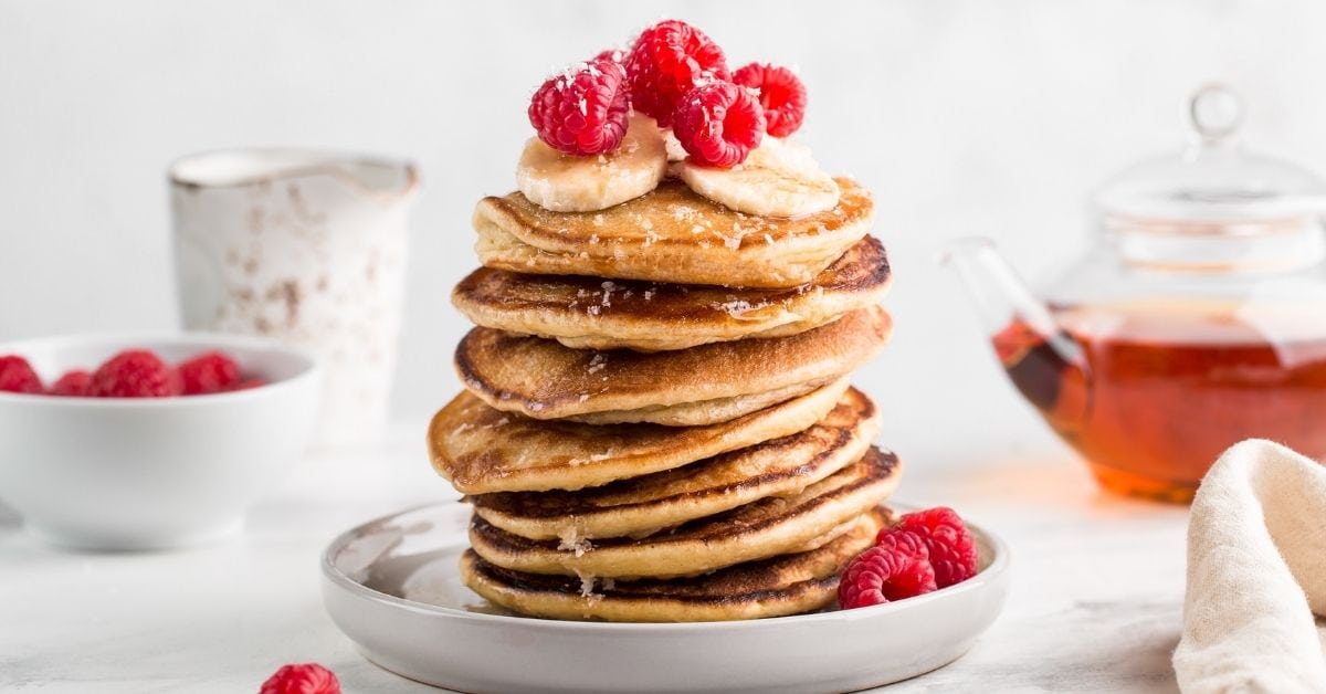 Stack of Pancakes with Banana Slices and Raspberries