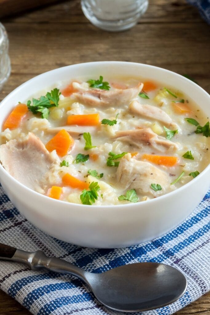 30 Easy Broth Based Soups You'll Love featuring Warm Chicken and Rice Soup in a Bowl