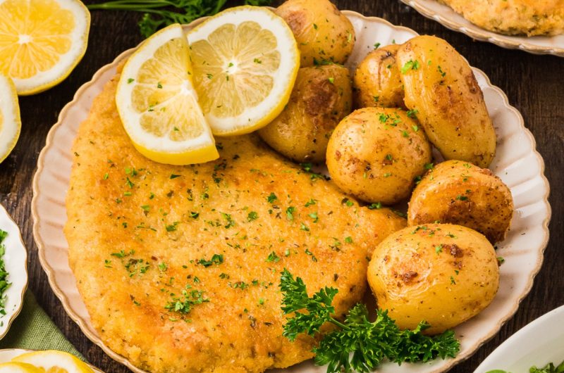 Wiener Schnitzel: breaded veal cutlets served with mashed potatoes and lemon wedges.