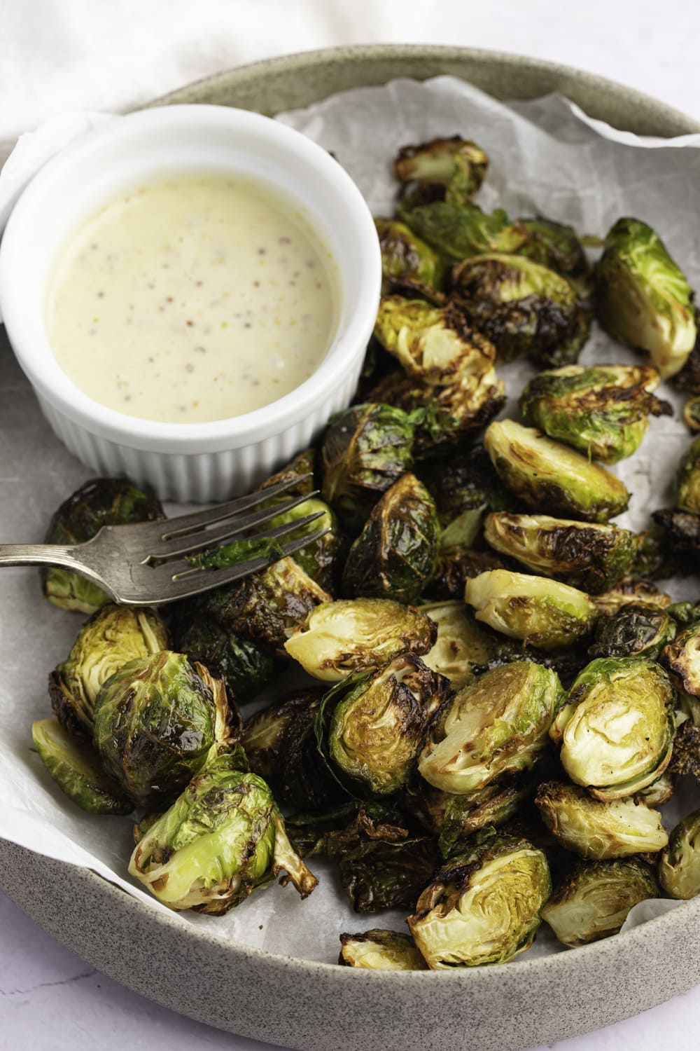 Roasted brussels sliced in halves served with a dipping sauce.