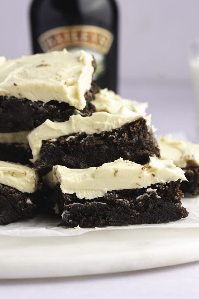 Bailey's Irish Cream Brownies with Bailey's Bottle in the Background