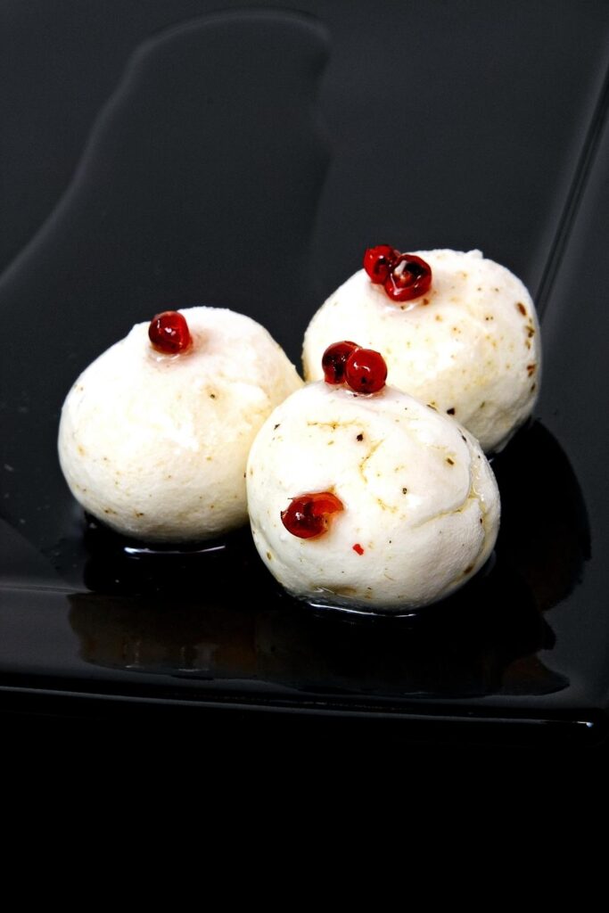 Boursin Cheese Balls with Peppercorns served on a Black Plate