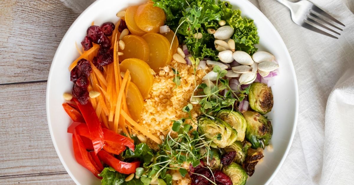 Bowl of Healthy Salad with Gold Beets, Carrots, Brussel Sprouts and Couscous