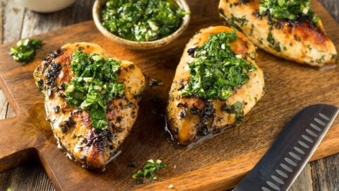 Homemade Grilled Chicken with Pesto in a Wooden Cutting Board