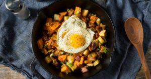 Homemade Healthy Sweet Potato Hash with Eggs in a Skillet
