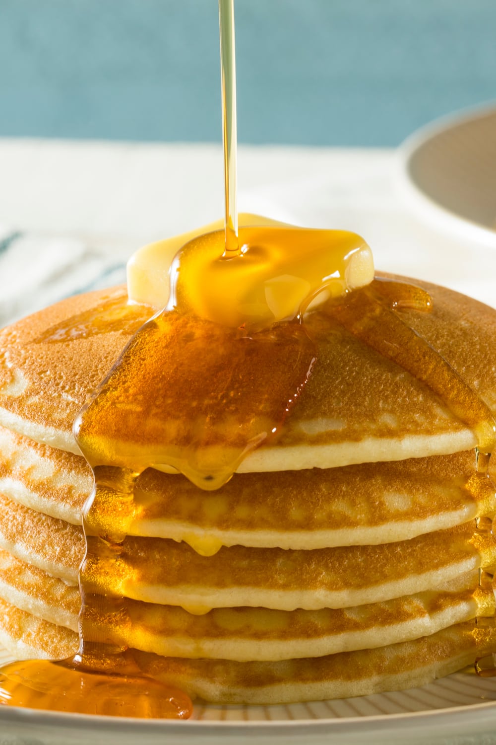 Jiffy Cornbread Pancakes Drizzled With Syrup and Butter on Top