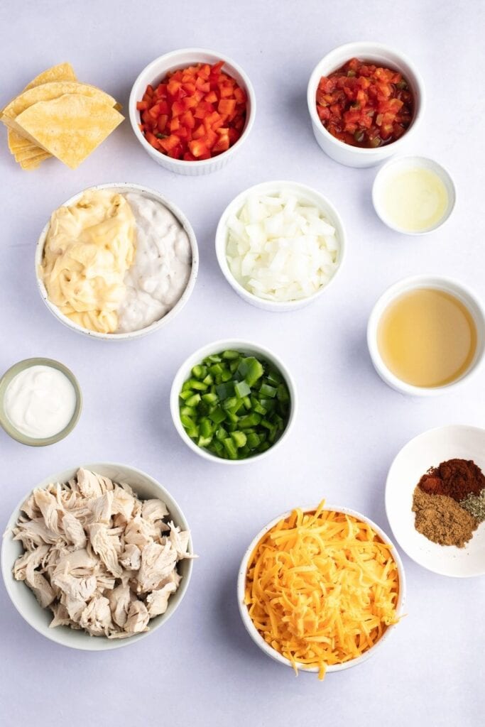 King Ranch Casserole Ingredients - Chicken, Onion, Bell Peppers, Condensed Soup, Canned Tomatoes, Chicken Broth, Sour Cream, Spices and Seasonings, Cheese and Corn Tortillas