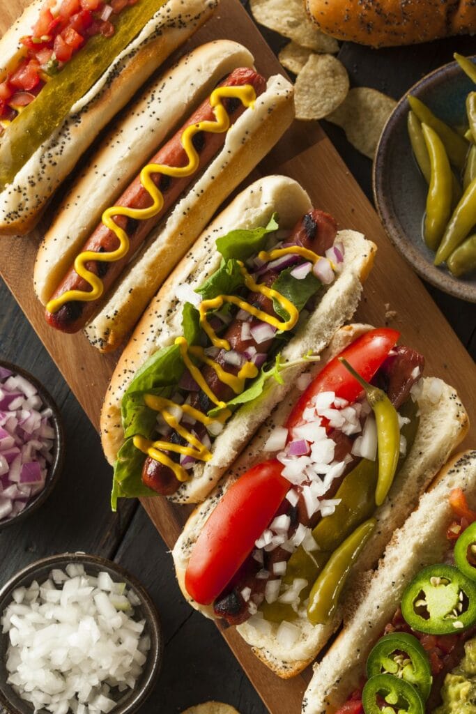 Assorted Gourmet Grilled Hot Dogs with Sides and Chips