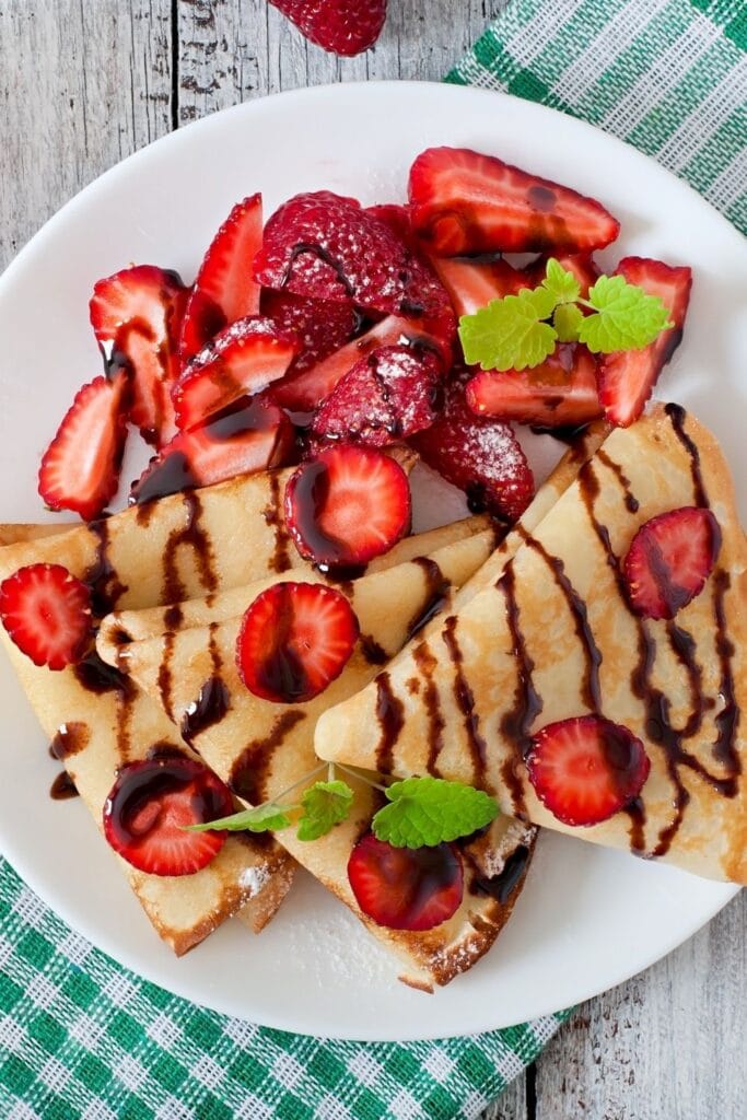 Cassava Flour Pancakes with Strawberries and Chocolate Syrup