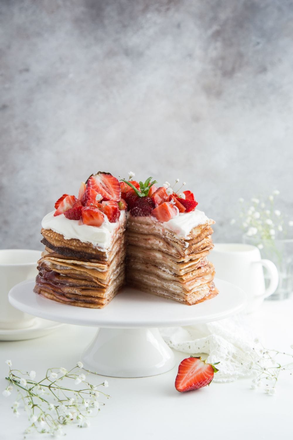 Crepe Cake with Frosting and Fresh Strawberries on Top