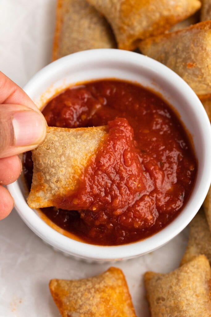 Dipping Pizza Rolls in a Tomato Sauce