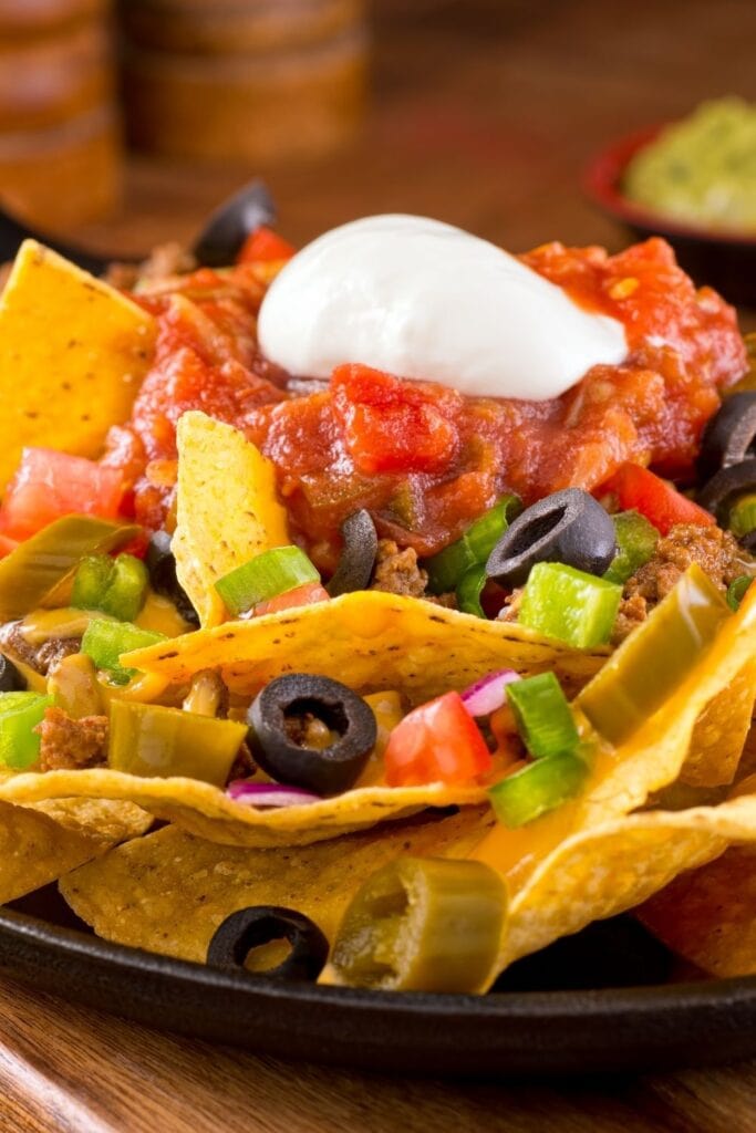 These Doritos recipes will blow you away with their awesome flavor and crunch! Dorito Nachos shown in picture with Black Olives, Cream and Salsa.