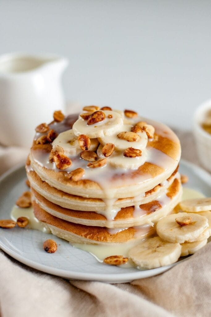 Stack of Powdered Milk Pancakes with Condensed Milk, Bananas and Nuts