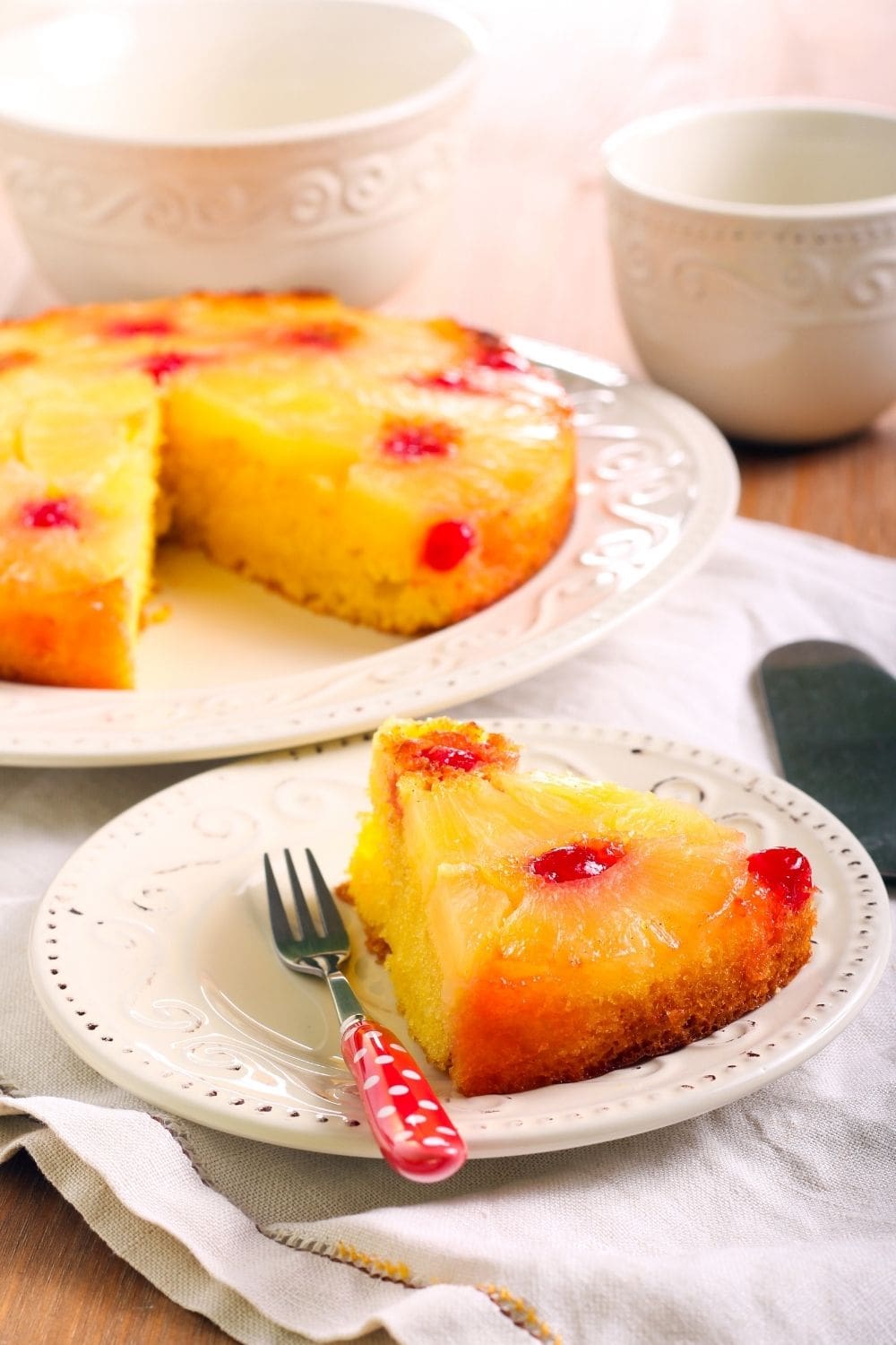 Slice of Pineapple Upside Down Cake on a Plate with a Fork 
