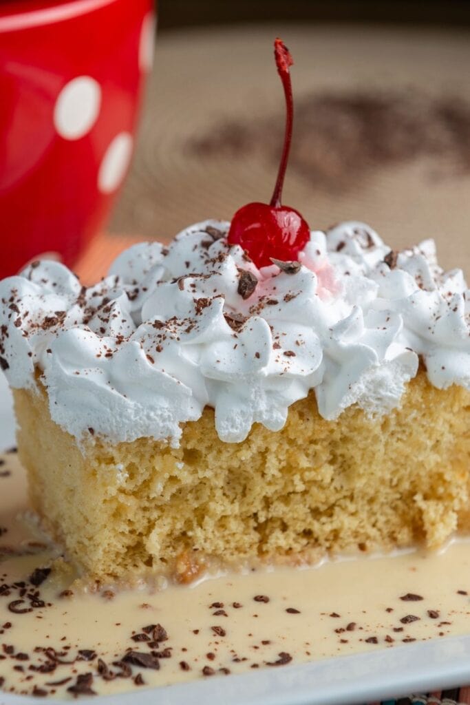 Tres Leches Cake with Chocolate Shavings and a Cherry on top