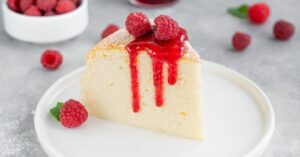 A Slice of Sweet Homemade Japanese Cotton Cheesecake with Raspberry and Sauce
