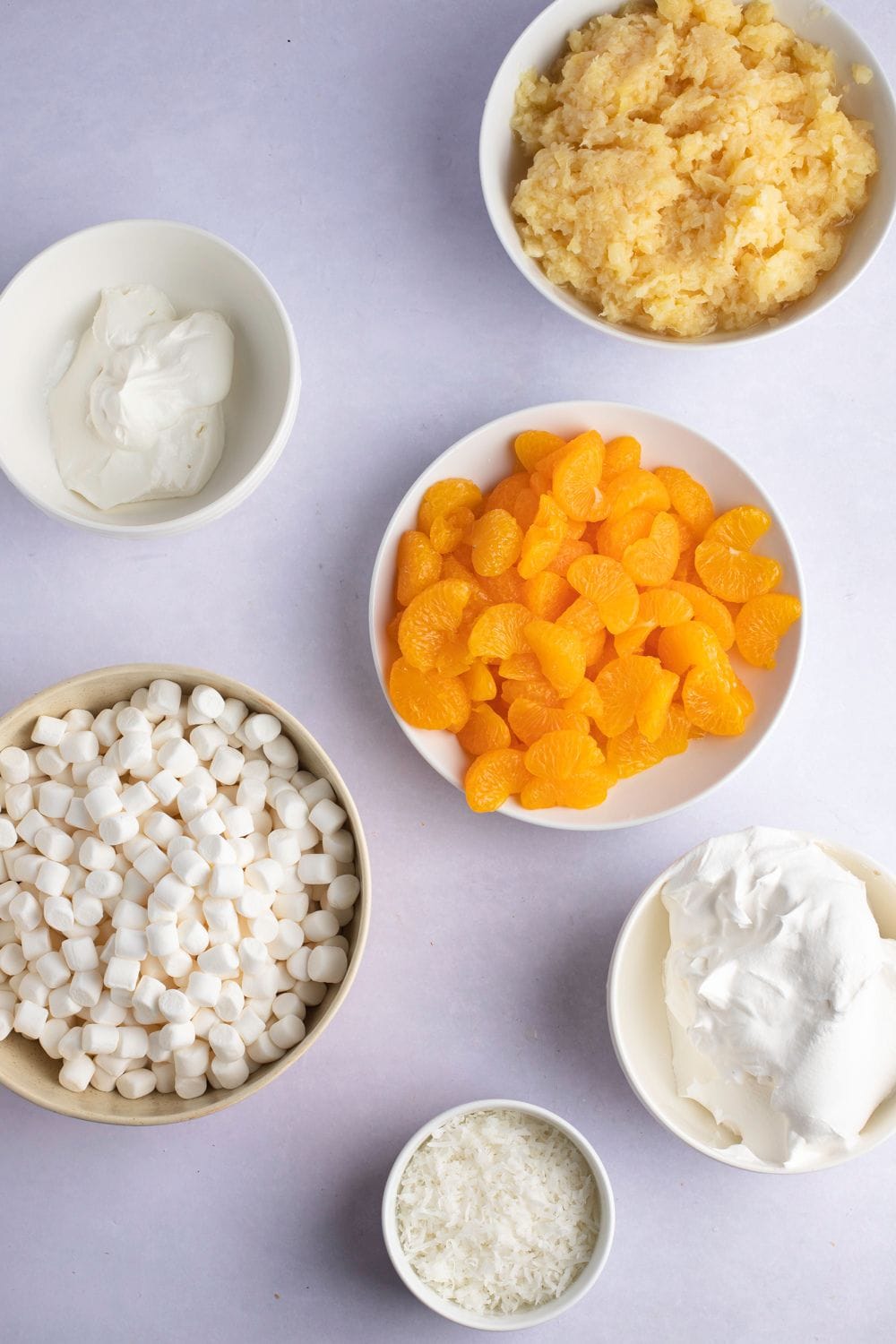 Ambrosia Fruit Salad Ingredients - Canned Pineapple and Mandarin Oranges, Shredded Coconut, Cool Whip, Sour Cream and Mini-Marshmallows