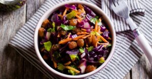 Bowl of Homemade Vegetable Salad with Cabbage, Carrots and Raisins