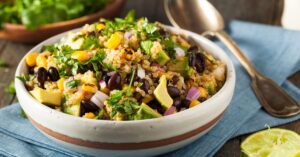 Bowl of Quinoa Salad with Beans, Corn, Cilantro and Avocados