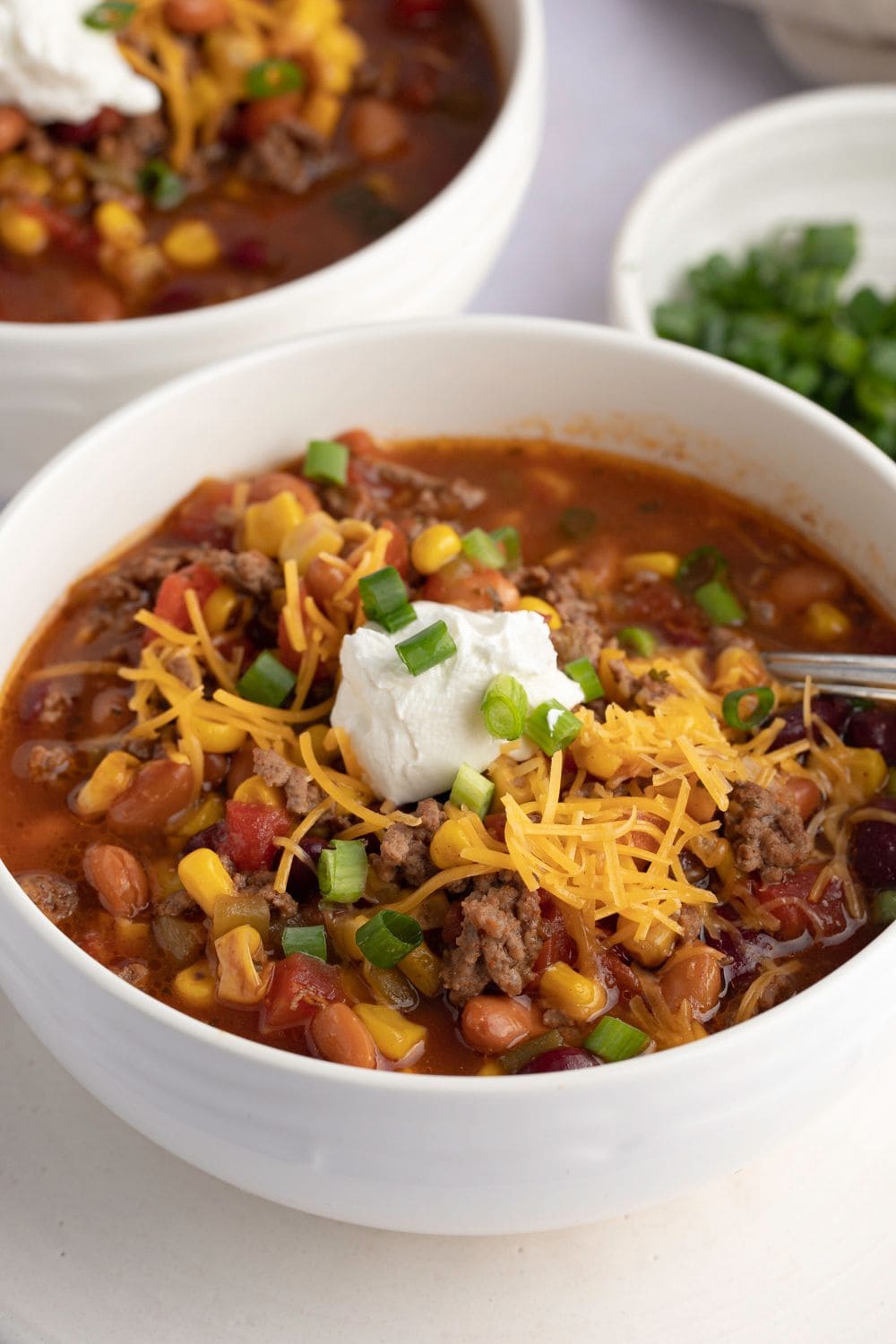 Bowl of Warm Crockpot Taco Soup with Ground Beef and Beans