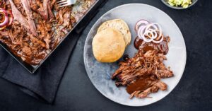 Comforting Homemade Pulled Pork with Bread, Onions and Sauce