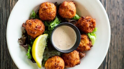 Homemade Conch Fritters with Greens, Lemons and Dipping Sauce