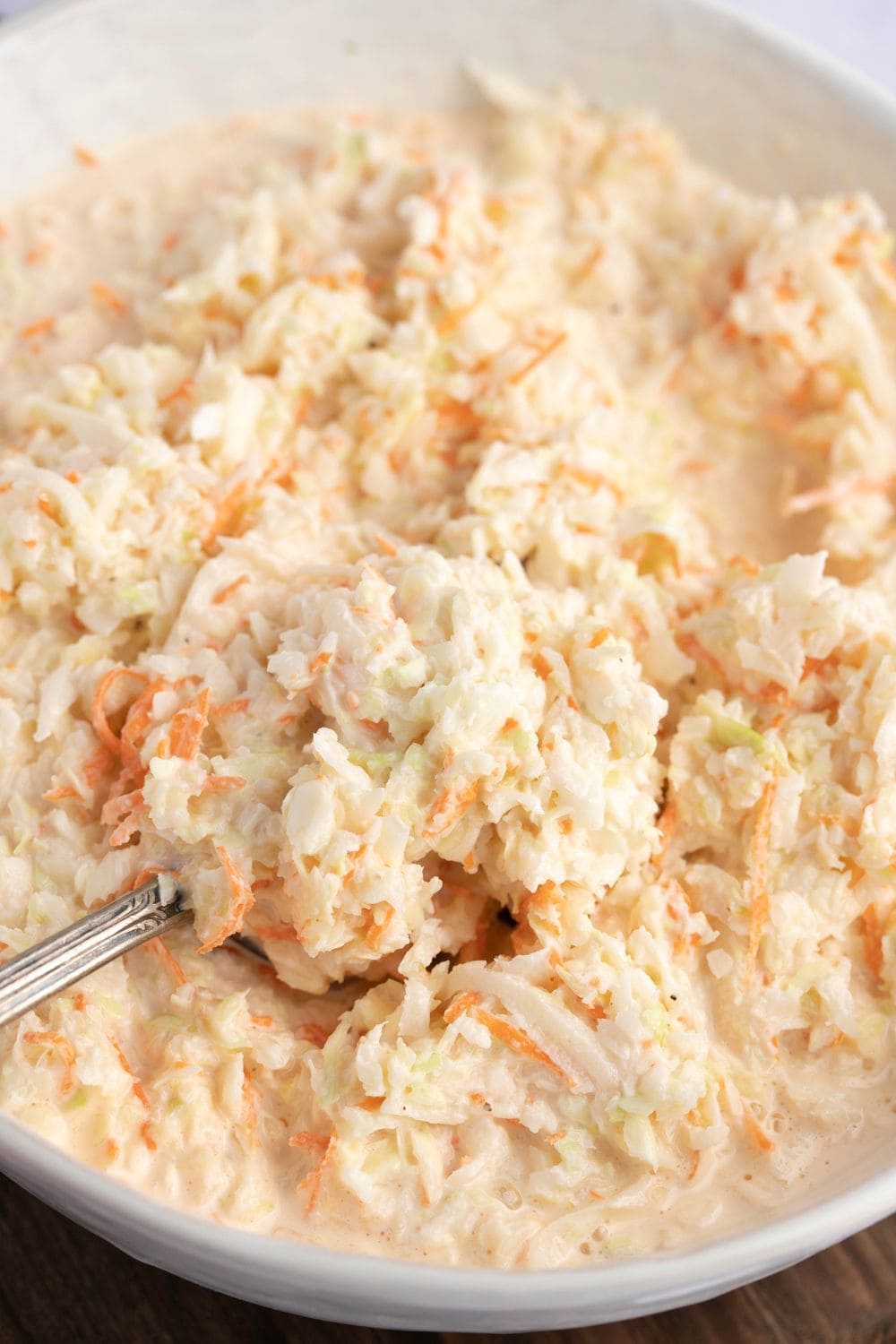 Creamy coleslaw with shredded cabbage and carrots.