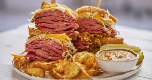 Homemade Reuben Sandwich with Dipping Sauce and Potato Chips