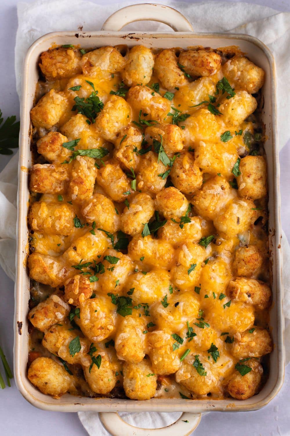 Tater Tot Casserole in a white baking dish, top view