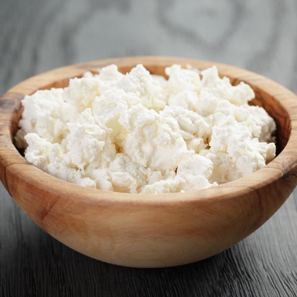 Crumbled Ricotta Cheese in a Wooden Bowl