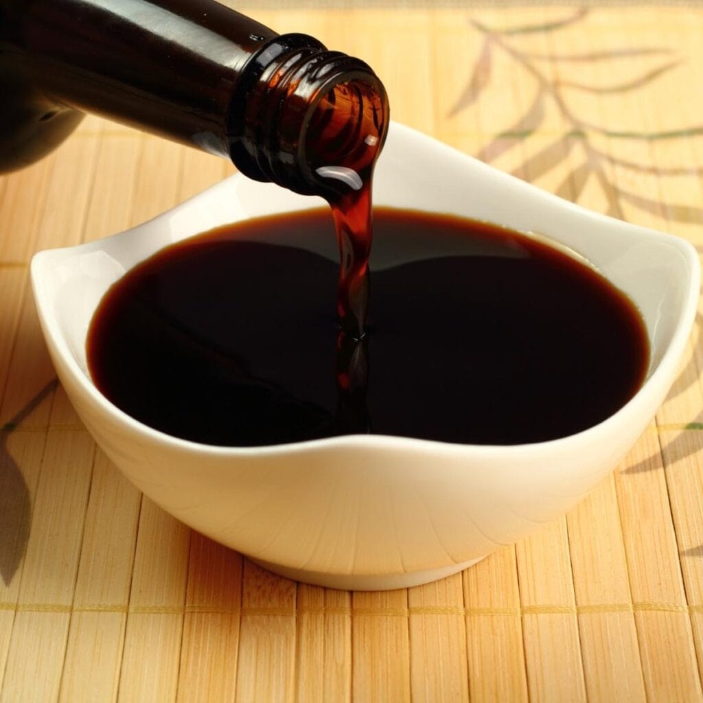 Soy Sauce Poured in a Small White Dish