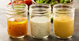 Variety of Homemade Salad Dressing in Mason Jars Including Vinagrette, Ranch and Honey Mustard
