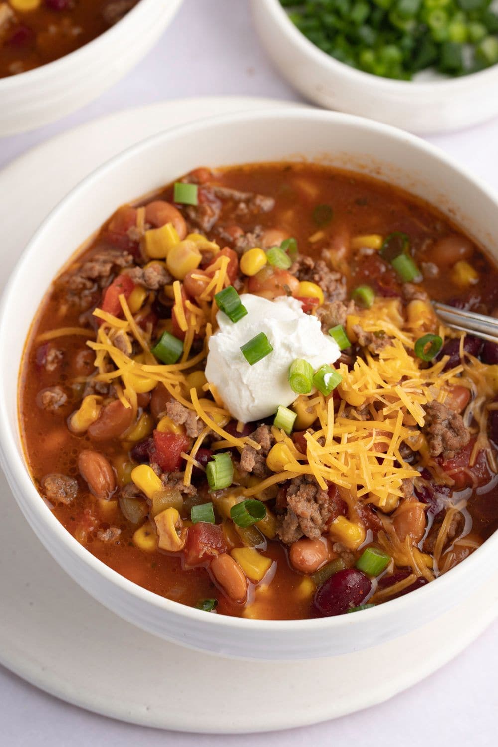 Warm of Bowl of Crockpot Taco Soup with Beans, Cheese, and Sour Cream