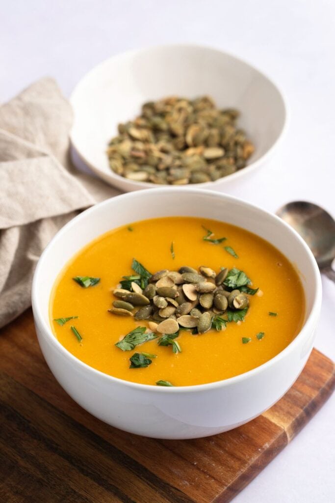 Warm Homemade Butternut Squash Soup with Butternut Squash Seeds and Herbs