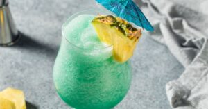 Boozy and Refreshing Blue Hawaiian Cocktail with Pineapple and Rum