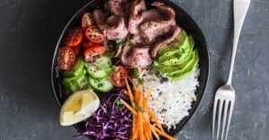 Bowl of Beef Steak and Rice with Avocados, Tomatoes and Cucumber