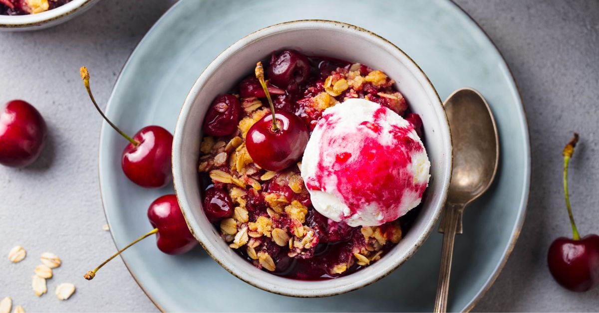 Bowl of Homemade Cherry Crumble with Ice Cream