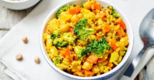 Bowl of Homemade Quinoa Curry with Carrots and Broccoli